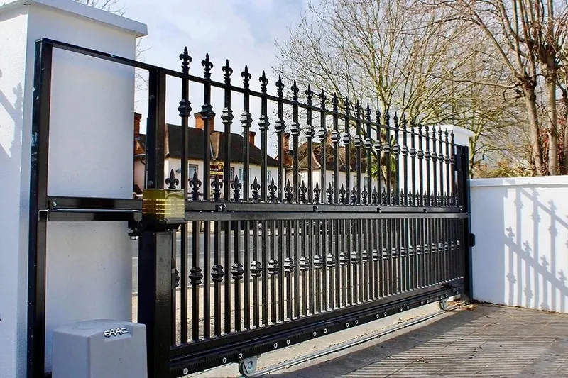 An automatic driveway gate part-way through its opening cycle
