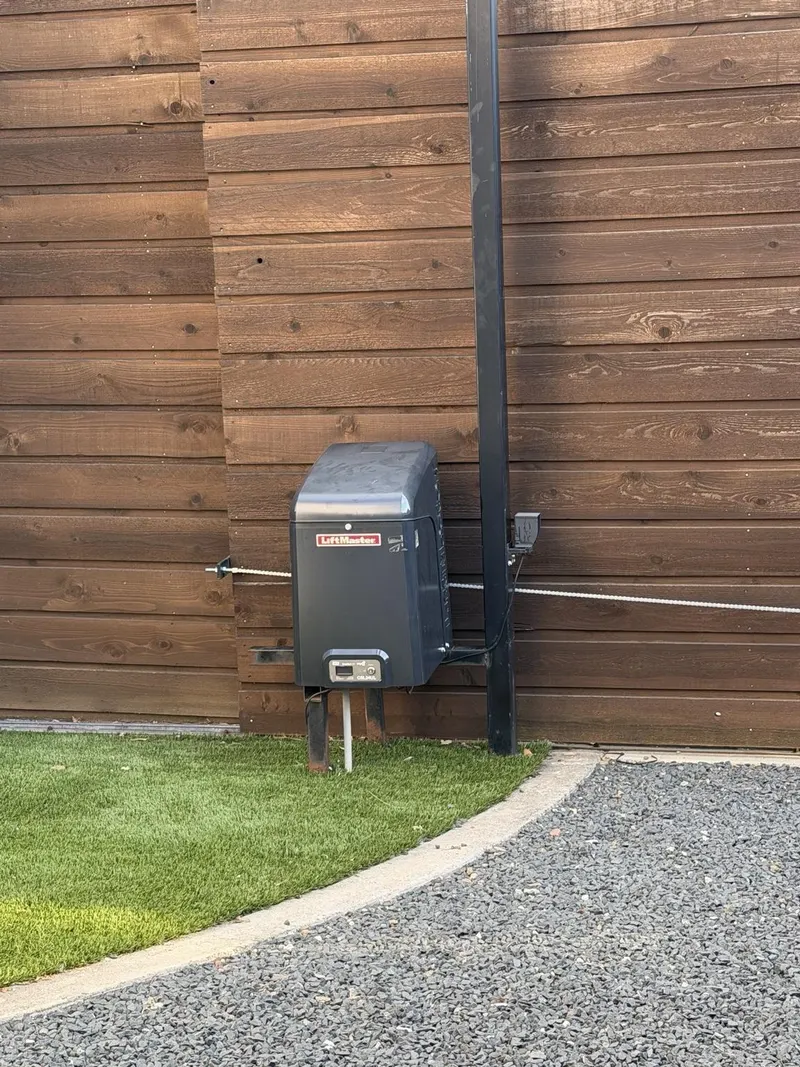 LiftMaster operator and replacement chain installed on the sliding gate.