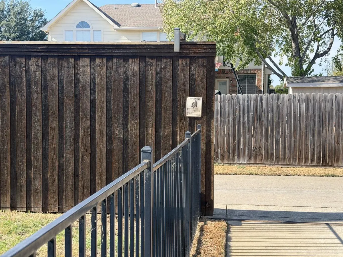 View of the sliding gate and driveway opening.