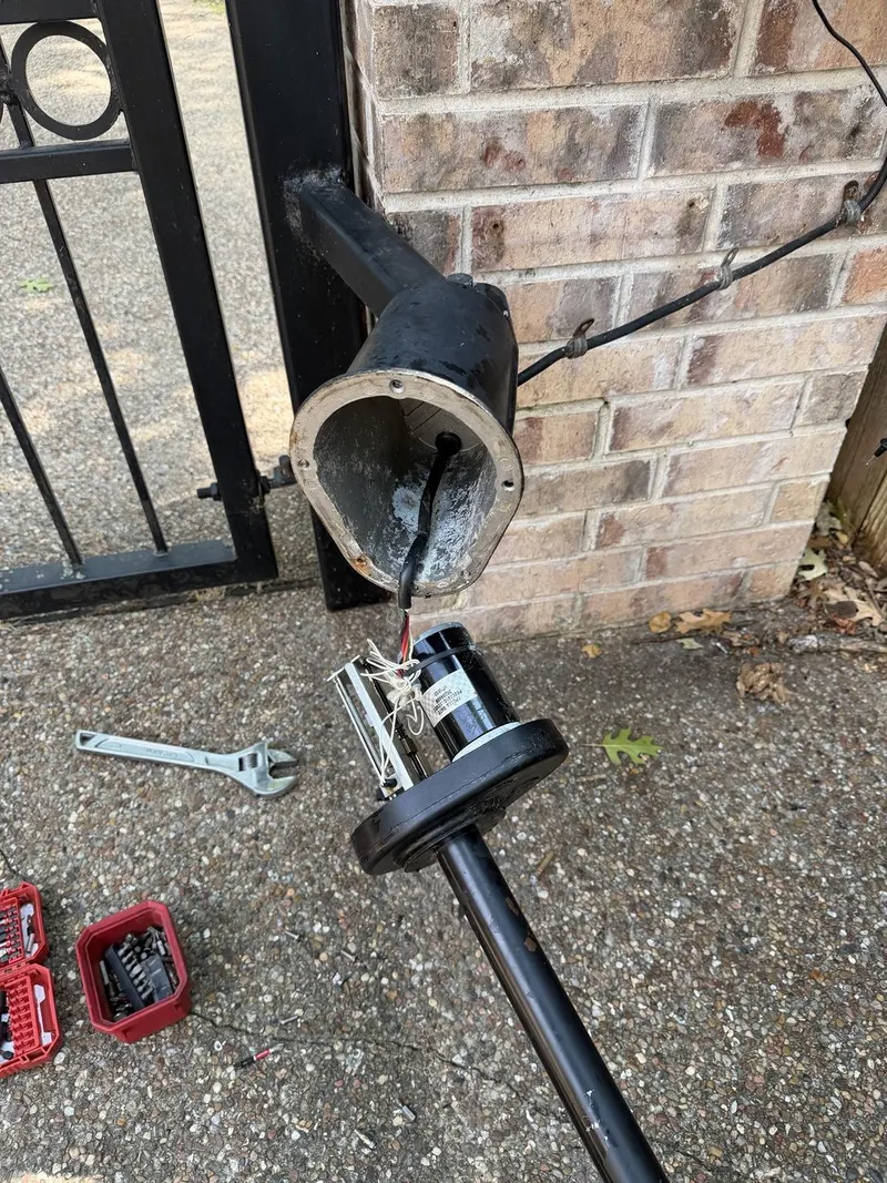Existing gate arm opened for repair rather than replaced.