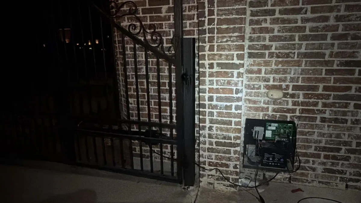 Gate operator arm and control enclosure during the service visit.