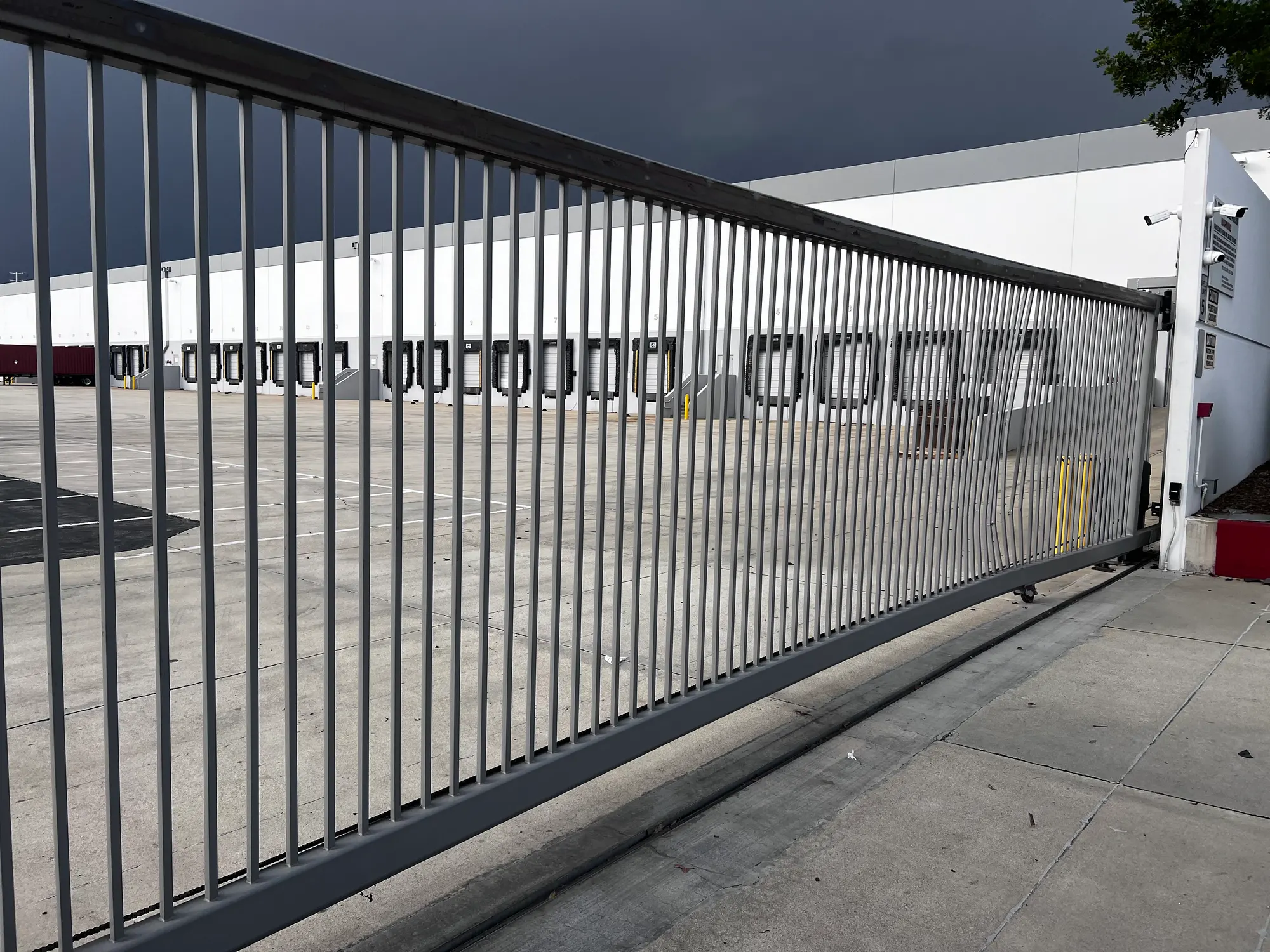 The impact-damaged slide gate in position at the warehouse entrance before repair