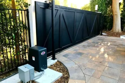 An Eagle gate operator housing beside a sliding driveway gate