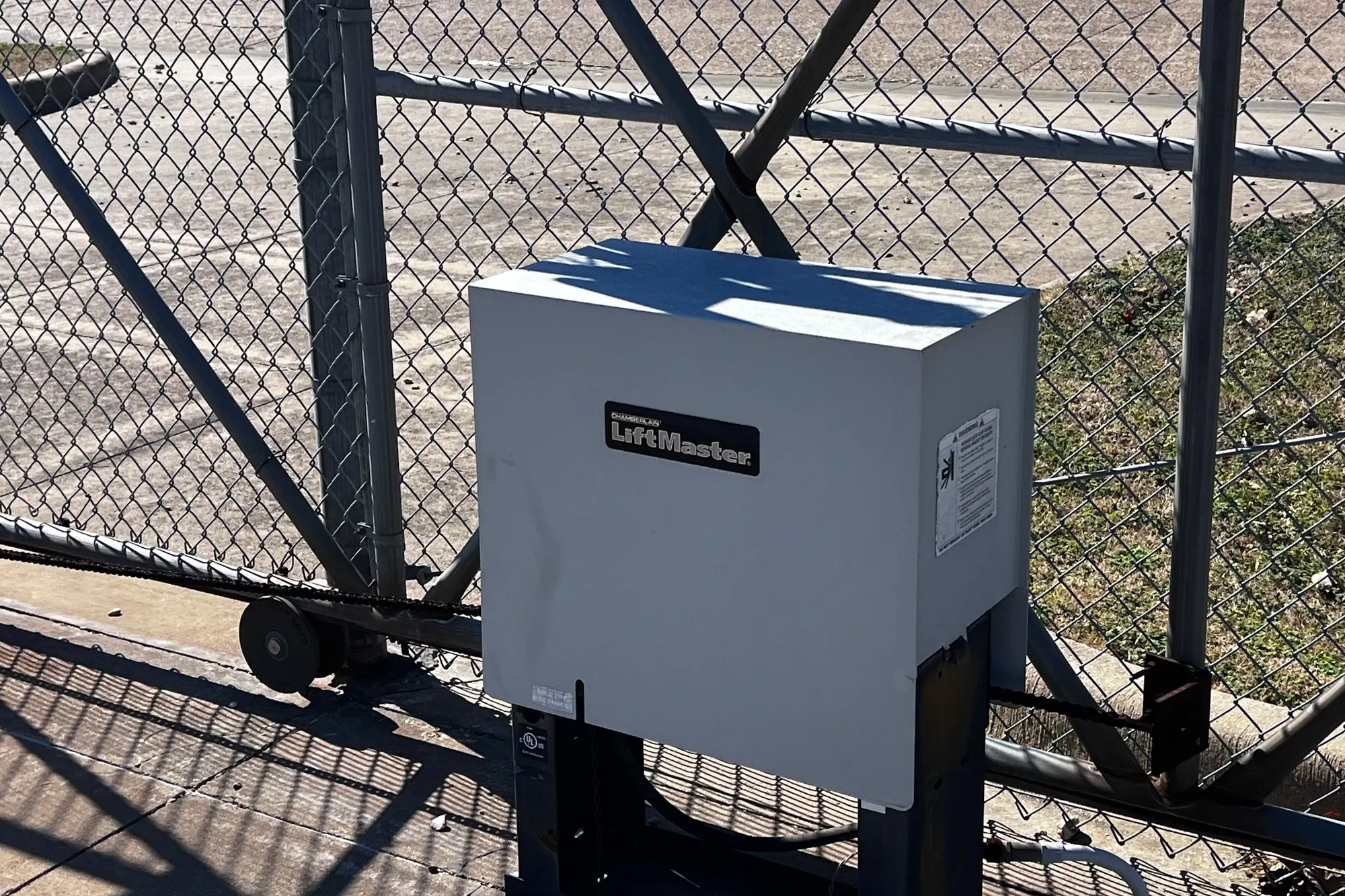 A LiftMaster gate operator housing showing weather damage and corrosion before repair