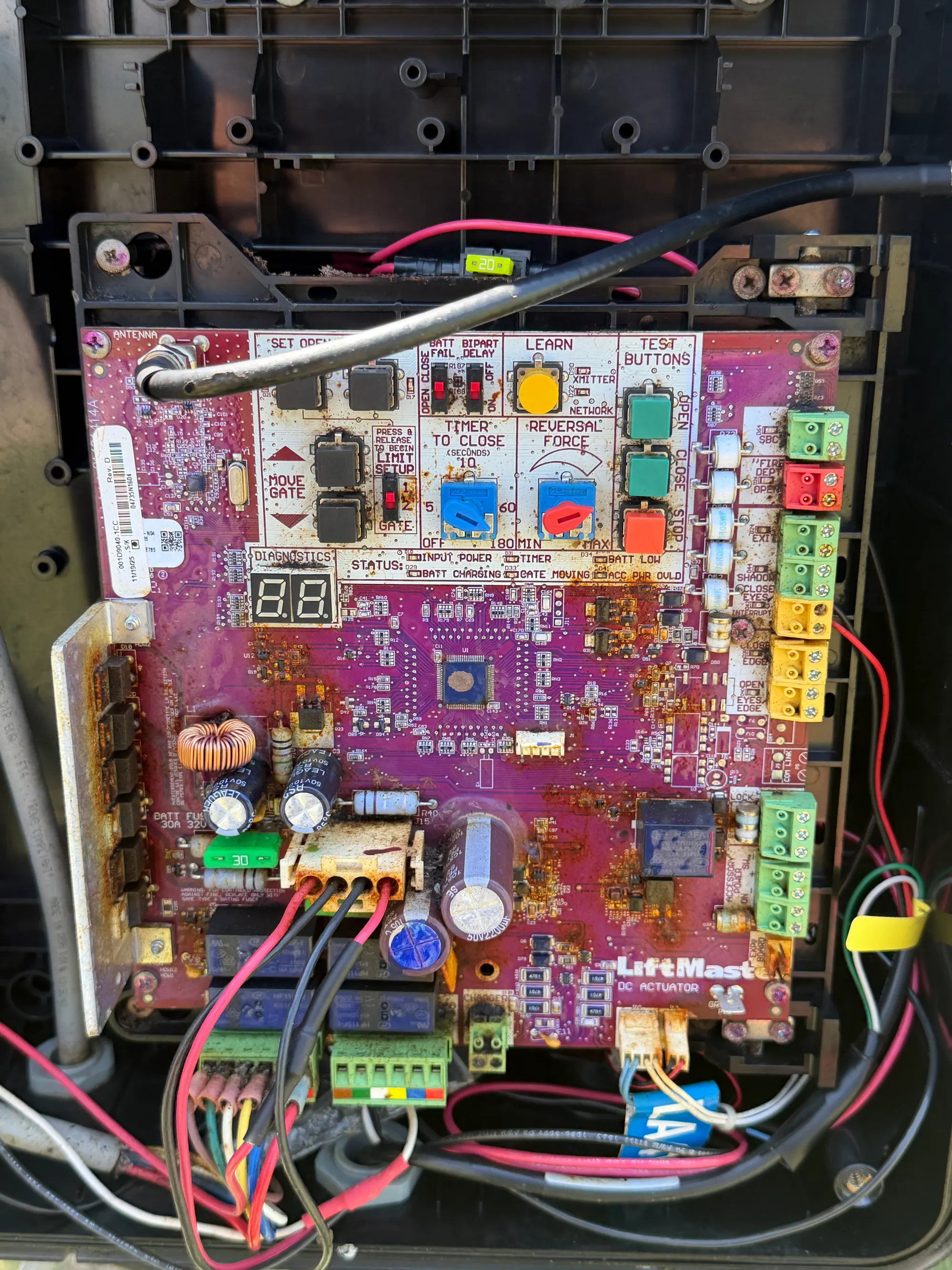 Close view of a LiftMaster control board with its terminal blocks, programming buttons and two-digit diagnostic display